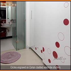 Circles engraved on Corian cladded wardrobe shutters
